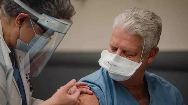 Director of nursing education Loraine Hopkins Pepe, left, administers the Pfizer BioNTech COVID-19 vaccine to Dr. Richard Fine, head of anesthesiology, at Einstein Medical Center in Philadelphia, Dec. 16, 2020. Striking a compromise between two high-risk population groups, a panel advising the Centers for Disease Control and Prevention voted Sunday to recommend that people 75 and older be next in line to receive the coronavirus vaccine in the United States, along with about 30 million &ldquo;frontline essential workers,&rdquo; including emergency responders, teachers and grocery store employees.