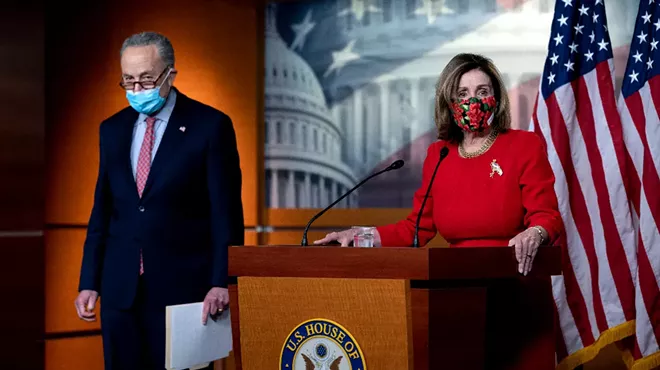 Senate Minority Leader Chuck Schumer (D-N.Y.) listens as House Speaker Nancy Pelosi (D-Calif.) speaks during a press conference at the Capitol in Washington, on Sunday, Dec. 20, 2020.