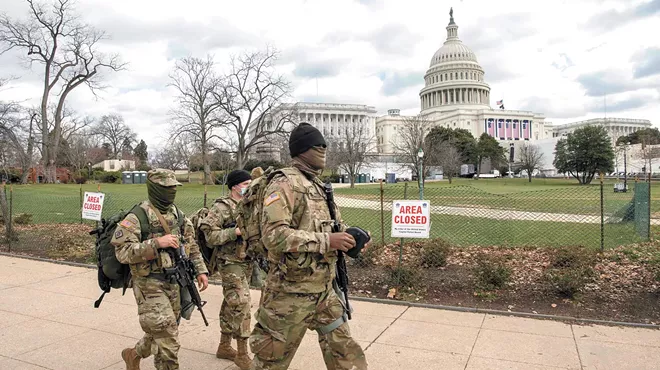 Soldiers assigned to the Virginia Army National Guard walk the fence line near the U.S. Capitol building earlier this week.