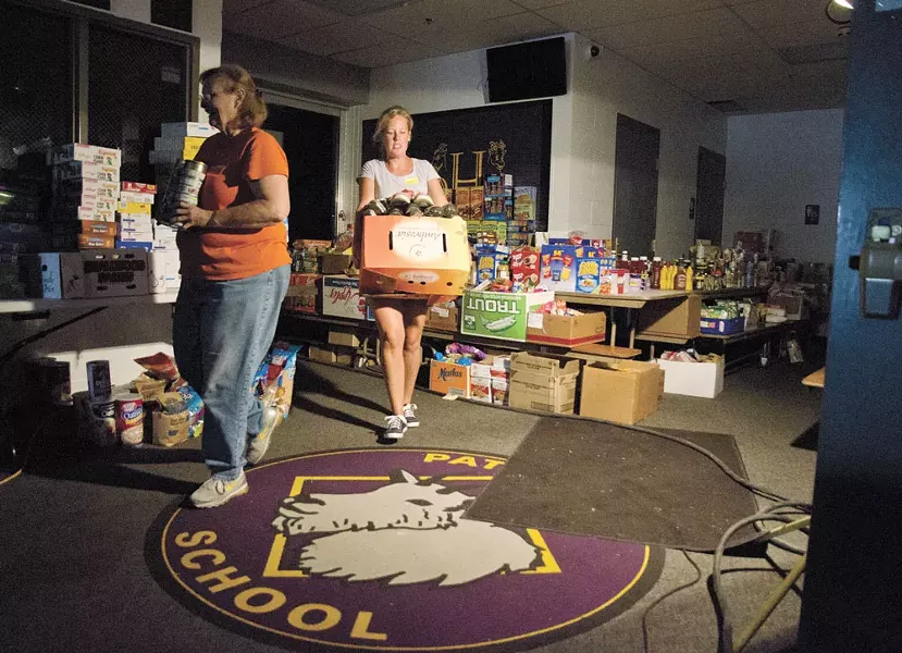 Volunteers sort and inventory donations at a relief center at Pateros High School for area residents displaced by the Carlton Complex Fire. - JACOB JONES