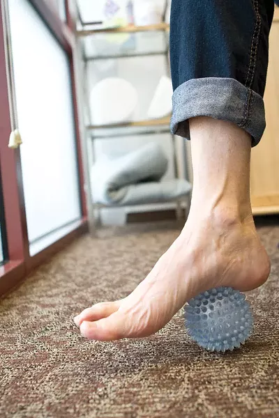 When Vi Hunter hurt her foot, she found out its a common injury. One therapy method has Hunter use a spikey doggy ball to get back on her feet. - STEPHEN SCHLANGE