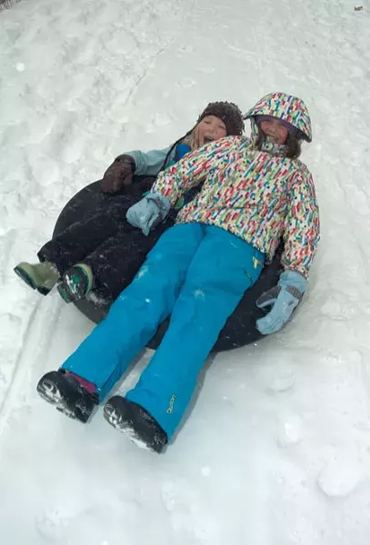 Guinevere Brownell and Kristin DeGraff tube down Mt. Philo