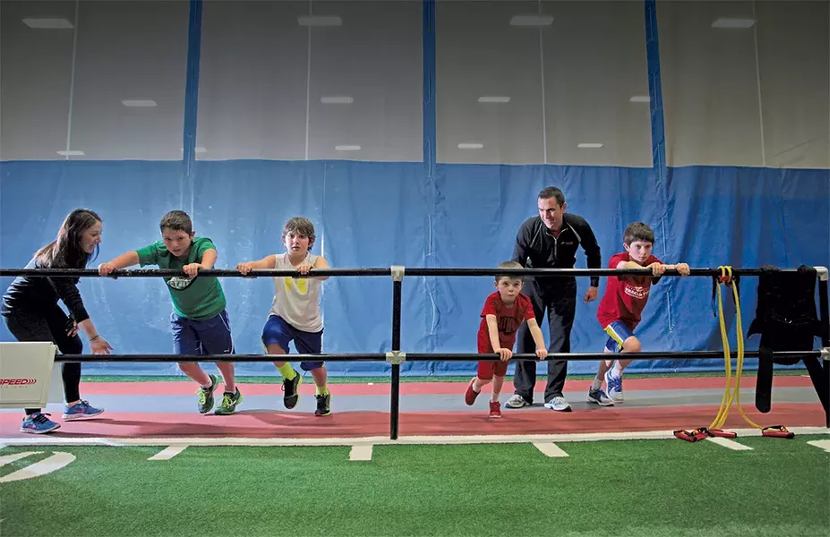 Performance coach Lauren Green and program director Mike Porter lead a Jump Start class, for ages 7 to 11, through the Wall Drive, an acceleration drill. - MATTHEW THORSEN