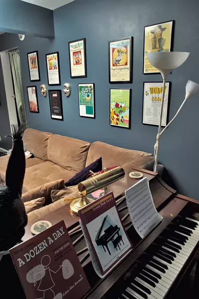 Theater posters in the family's den
