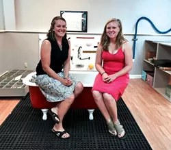 Blais and Spisiak sit on a clawfoot tub in the studio's sensory area - ALISON NOVAK
