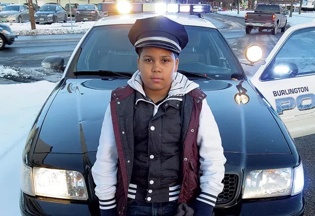 Javain Headley checks out a Burlington police cruiser. - MATTHEW THORSEN