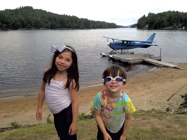 Manya and Ezra at a beach across from the Adirondack Hotel