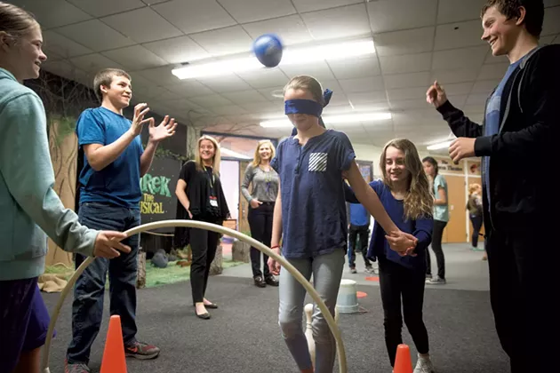 Mia White leading Ave Barron through a visual impairment station at Williston Central School - JAMES BUCK