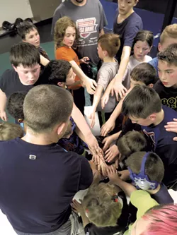 The Cobras huddle - MATTHEW THORSEN