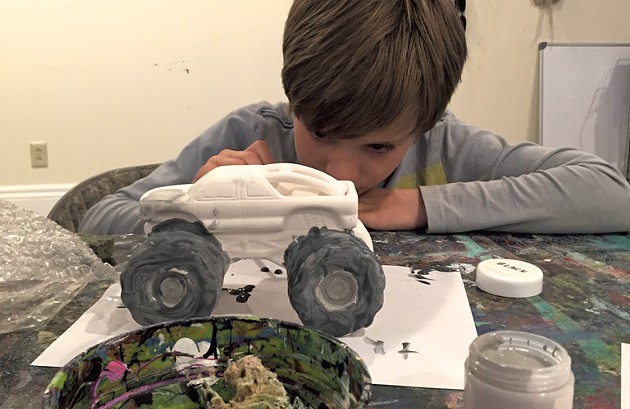 Theo paints his monster truck - ALISON NOVAK