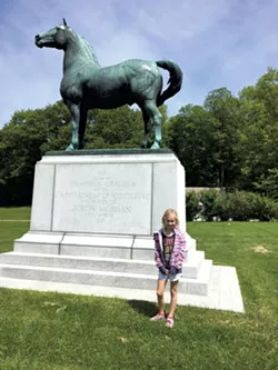 Dillon with a statue of Figure - SARAH TUFF DUNN