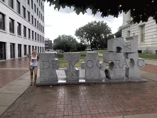 Grace Heller next to W.F. Herrick's sculpture "Democracy" in Burlington (Activity 50)