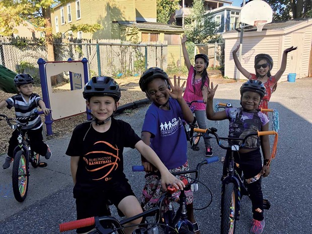 Kids in Sara Holbrook's elementary afterschool program bike in the center's back lot - COURTESY OF SARA HOLBROOK COMMUNITY CENTER
