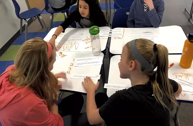 Middle school students at Shelburne Community School work on the evidence learning target
