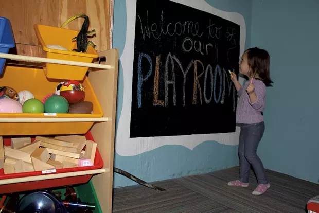 Sophie coloring on her chalkboard - MARY ANN LICKTEIG