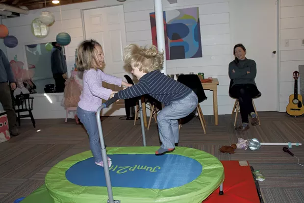 Mom Antonia looks on as her kids jump on the trampoline - MARY ANN LICKTEIG