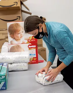 A volunteer bundling diapers in September - COURTESY OF AMANDA HERZBERGER