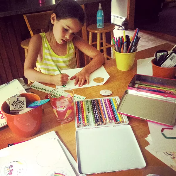 Ella making buttons