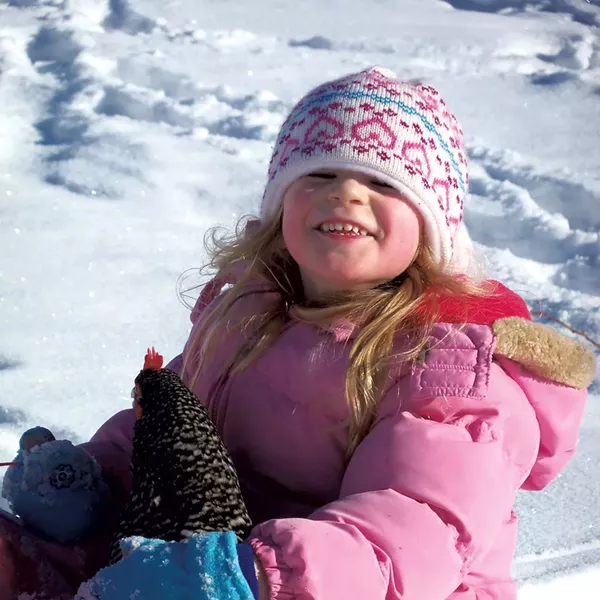 Natalee sledding with her chicken