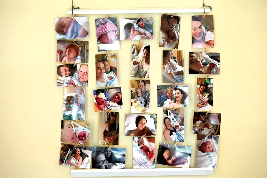 A wall of birth photos in Evolution's lobby - MATTHEW THORSEN