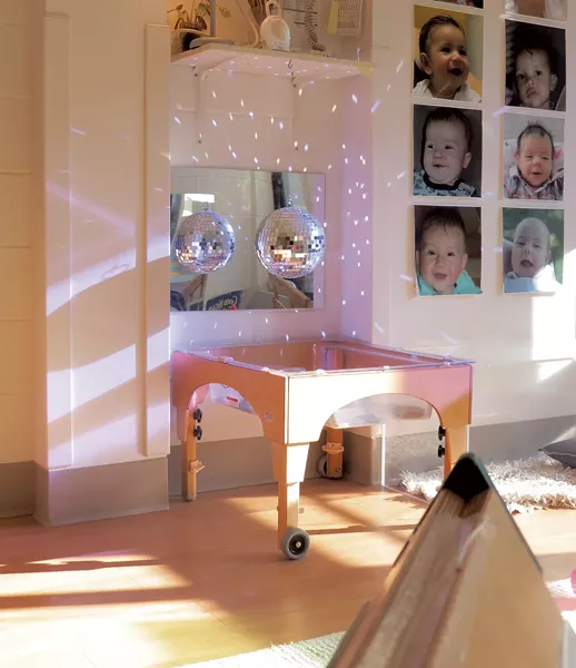 A disco ball casts sunlight across the wall at UVM's Campus Children's School