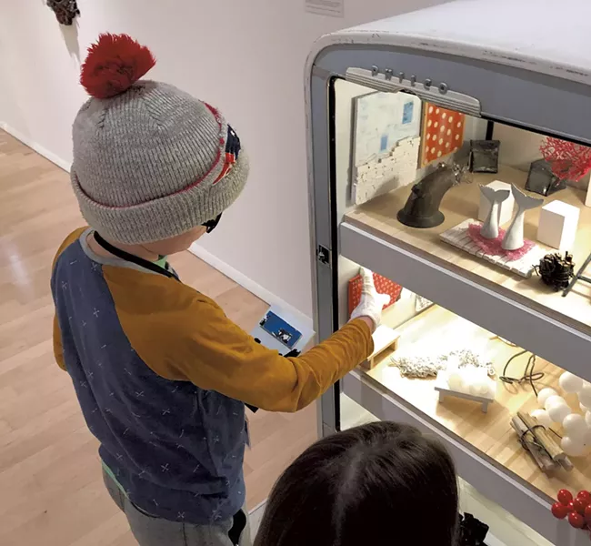Henry checks out Matt Neckers' open refrigerator - HEATHER POLIFKA-RIVAS