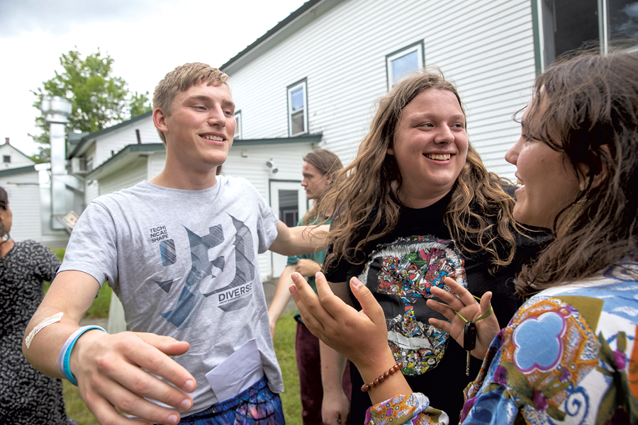ReTribers Peter Orzech, Riley Craig and Maddie Parker (left to right) embrace on the final day of Inner Journeys - JAMES BUCK