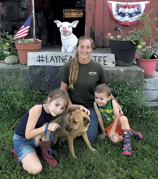 Heather and Natalie Layn with chicken club member Orion Ronark and a foster dog - BRETT ANN STANCIU