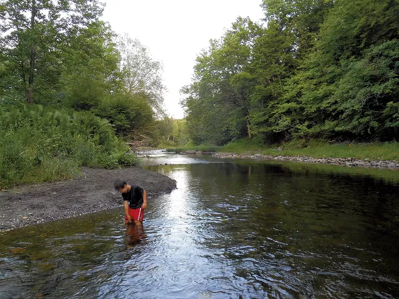 Heather's son Jesse wading in Québec's Tomifobia River in 2014 - HEATHER FITZGERALD