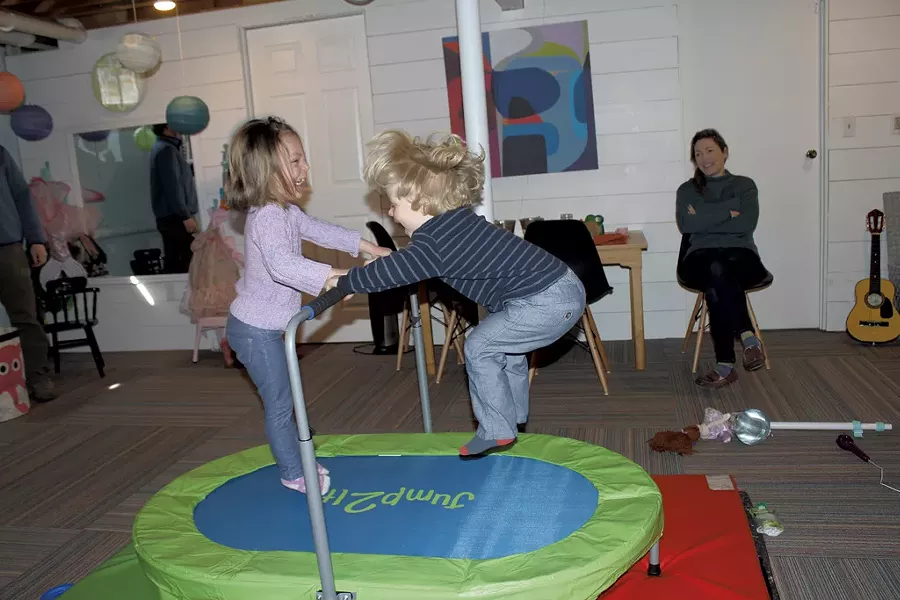 Mom Antonia looks on as her kids jump on the trampoline - MARY ANN LICKTEIG