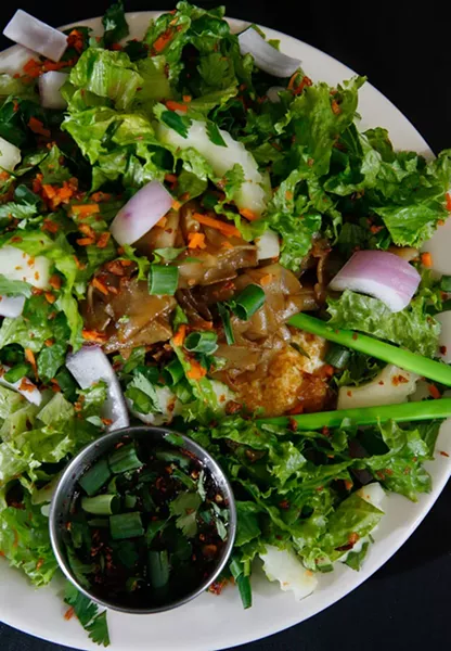 Twisted Triple Threat Tasty Salad, with fried egg, flat noodles, greens, carrots, onions, cucumber, cilantro and Thai dressing. - ROB WIDDIS