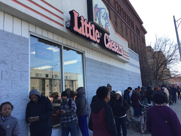 A line stretches down the street outside of Little Caesars in Highland Park during the Monday lunch hour. - ANTHONY SPAK