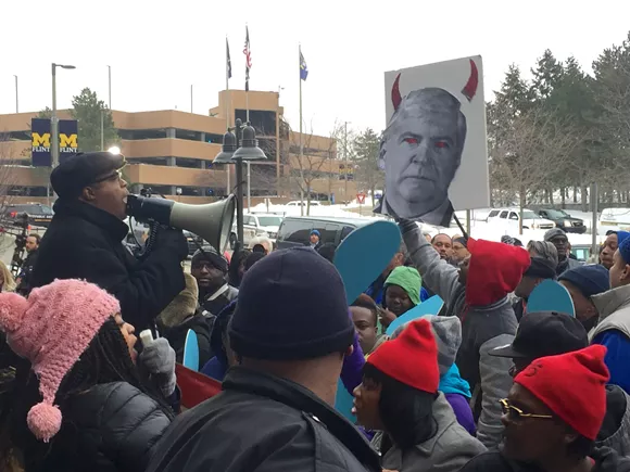Protesters chant "raise the wage, clean our water" and "you want our vote? Come get our vote!" outside the press area at Sunday's Democratic presidential debate in Flint. - PHOTO BY DUSTIN BLITCHOK