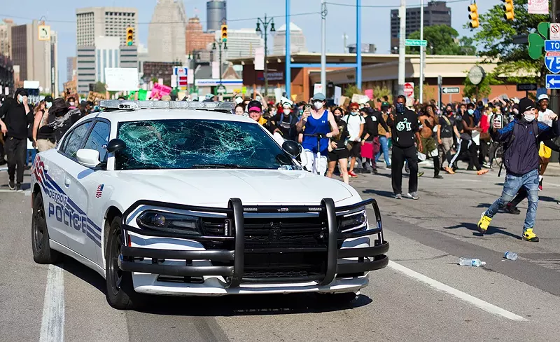 Protesters smashed the windows of a police car in Detroit. - STEVE NEAVLING