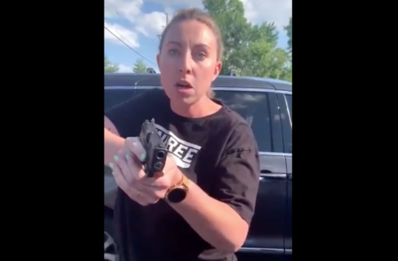 Screengrab of a woman pointing a gun at a Black woman in Oakland County. - TWITTER