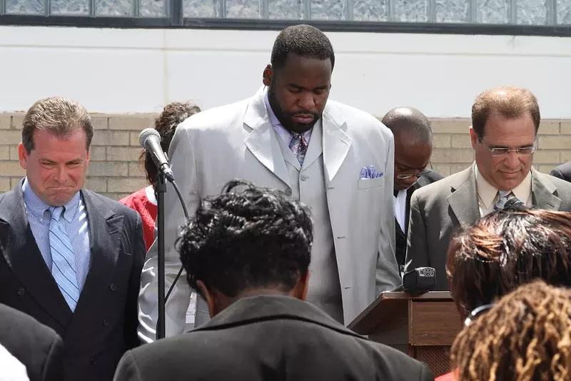 Kwame Kilpatrick and other officials at a public prayer rally. - SHUTTERSTOCK.COM