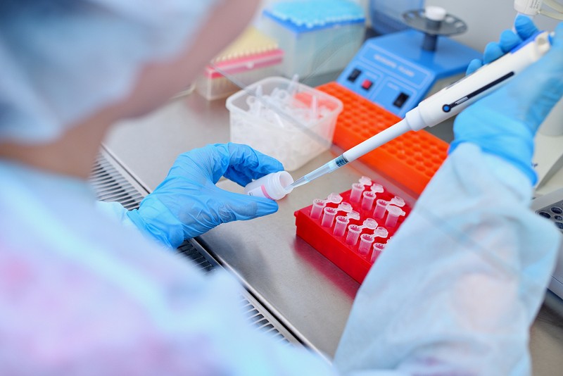 A laboratory technician conducting DNA analysis. - SALOV EVGENIY, SHUTTERSTOCK