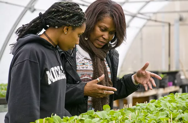 Nefer Ra Barber working with a student in a hoophouse that's used for the EAT program at Earthworks program. - TOM PERKINS