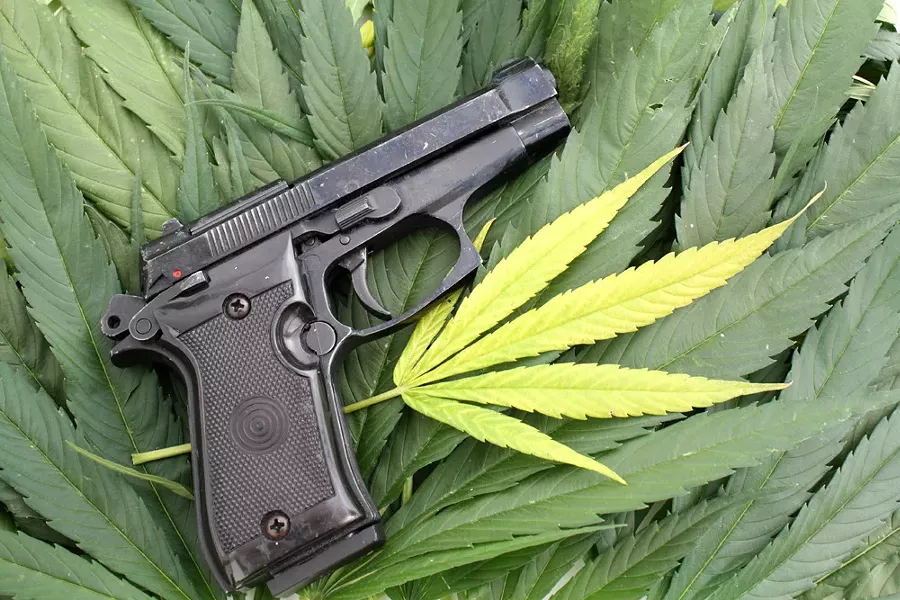 On the federal level, marijuana is still illegal, and it's a felony punishable by up to 10 years in prison to smoke pot and buy or own a gun. - SHUTTERSTOCK
