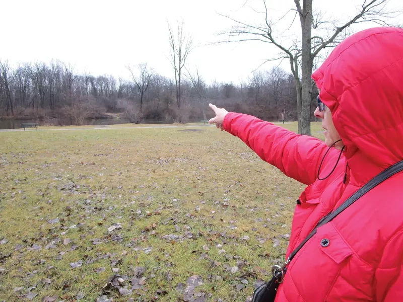 Kathy Schoen points to a bend in the river that would permanently lose more than two acres of trees if the pipeline gets built. - PHOTO BY MICHAEL JACKMAN