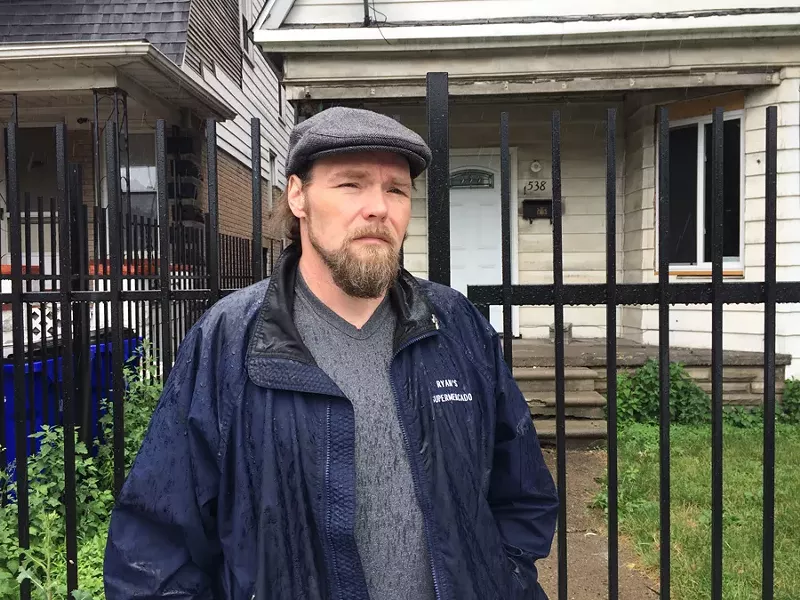 Joseph Bates, 48, stands in front of the Southwest Detroit home his great-great-grandparents bought in 1907. The home had been in his family until it was foreclosed due to unpaid tax bills. - VIOLET IKONOMOVA