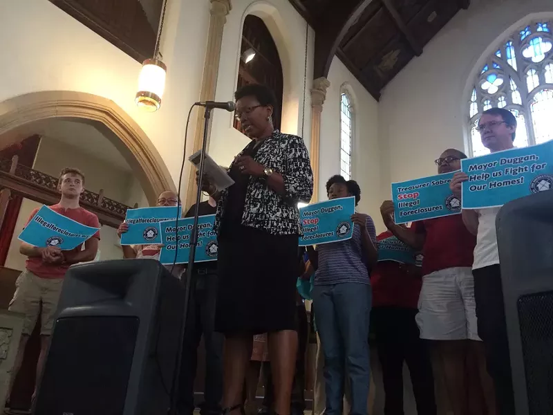 A staff member with the Community Development Advocates of Detroit calls on Mayor Mike Duggan to put a stop to what she and others call unconstitutional tax foreclosures. - VIOLET IKONOMOVA