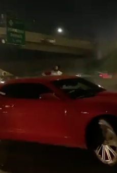 Red Camaro blows donuts on I-94.