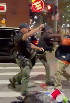 Screenshot of video showing a Detroit cop punching a man in the face in Greektown.