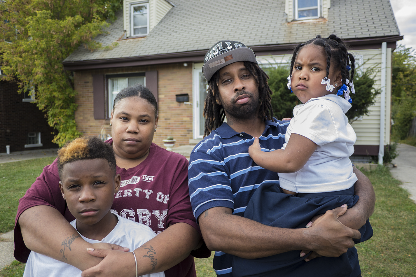 Shakiya Robertson stands in front of her foreclosed house with her husband Warren and two of their kids Kye'Ren and Kyi'Lei. - IAIN MAITLAND