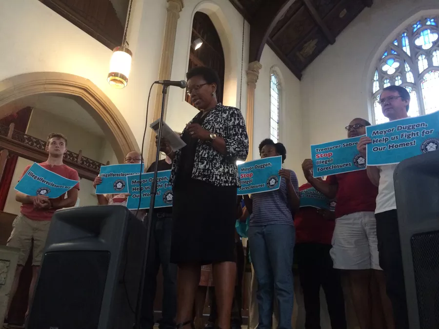 A staff member with the Community Development Advocates of Detroit calls on Mayor Mike Duggan to put a stop to what she and others call unconstitutional tax foreclosures. - VIOLET IKONOMOVA