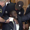 Detroit police yank police commissioner Willie Burton from his seat. Detroit police yank police commissioner Willie Burton from his seat.