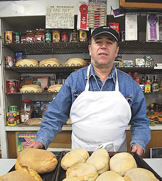 Vasile Sirca shows off his bakery's breads.
