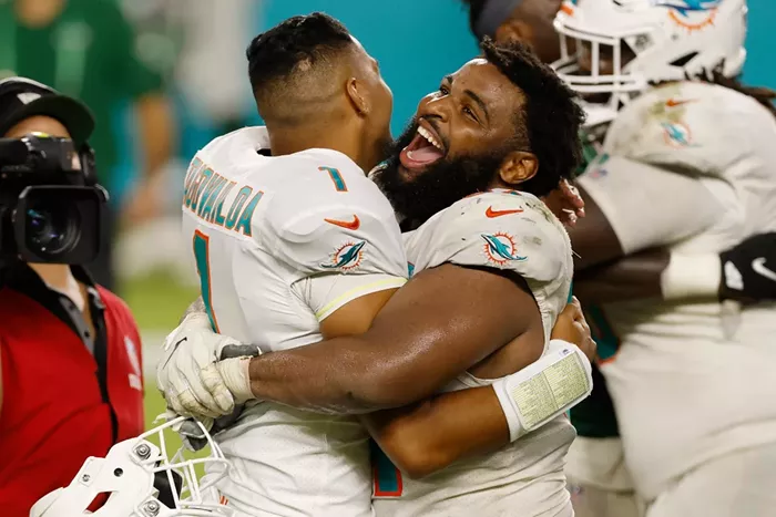 Christian Wilkins celebrates with Tua Tagovailoa after he made his NFL debut against the New York Jets. - PHOTO BY MICHAEL REAVES/GETTY
