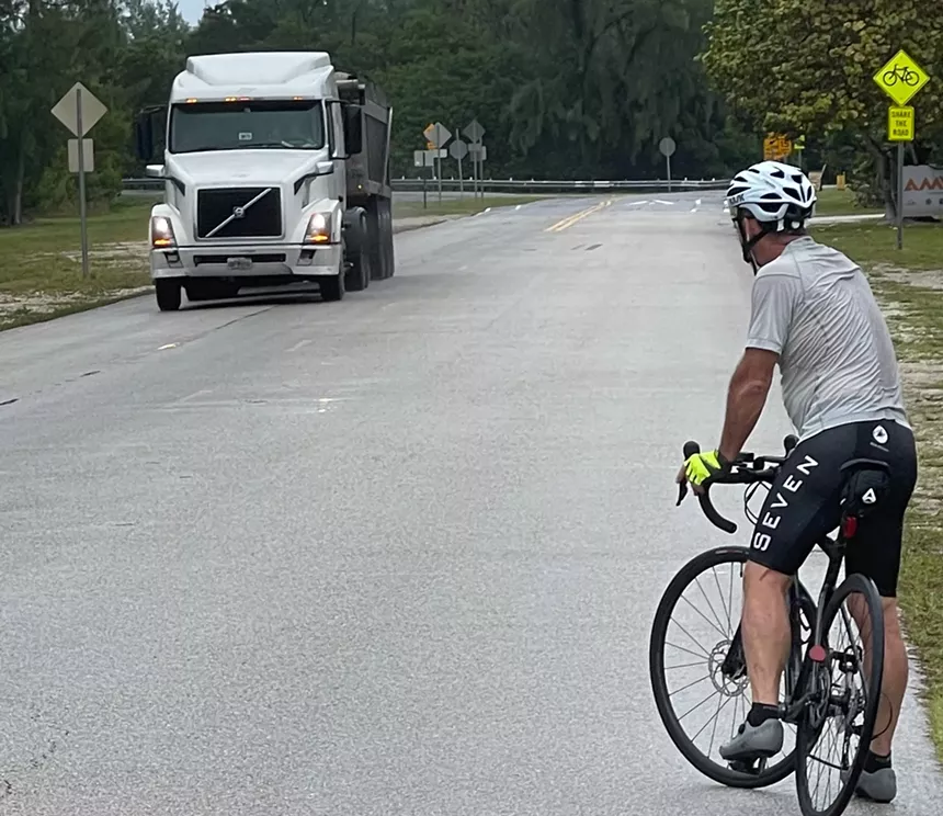 A cyclist crosses paths with a smelly wastewater truck on November 12, 2021, on Virginia Key. - PHOTO COURTESY OF IRA SAFERSTEIN
